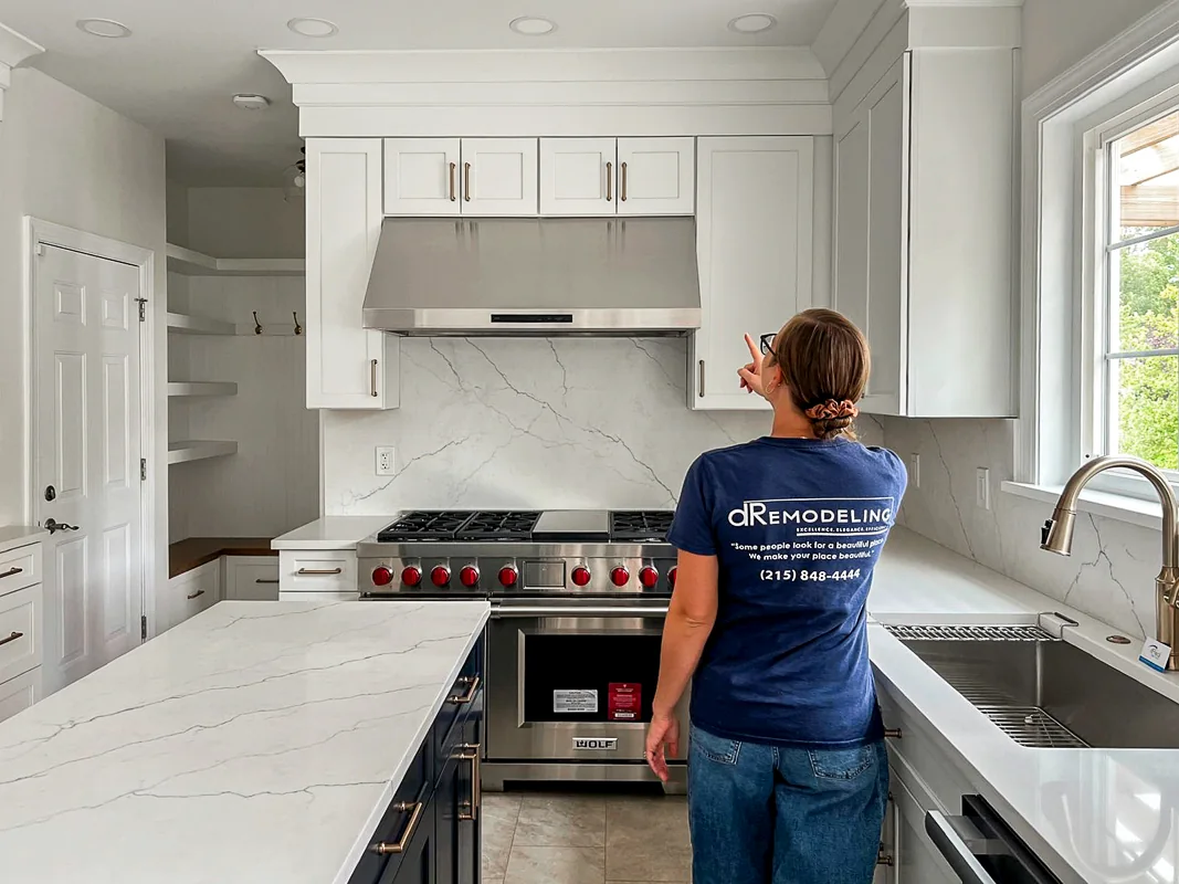 dRemodeling designer reviewing cabinetry during a Philadelphia kitchen project.